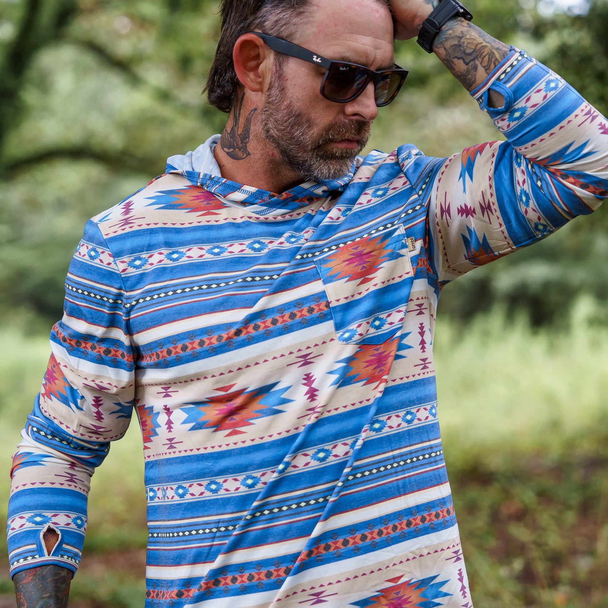Another perspective of the Men's Outdoors Long Sleeve Performance Hoodie by Combat Iron Apparel, displayed in nature.