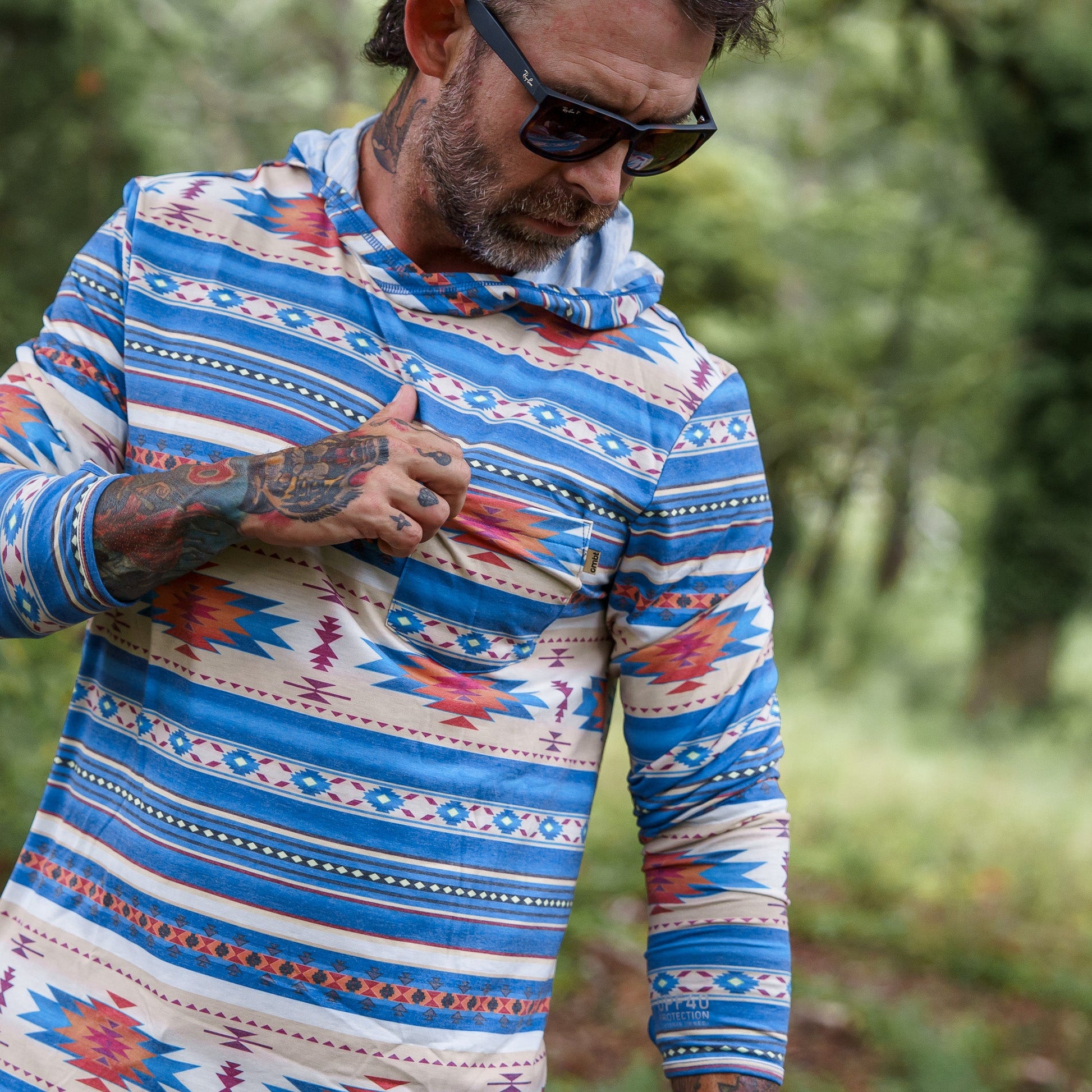 Men's Outdoors Long Sleeve Performance Hoodie, designed by Combat Iron Apparel, shown in vibrant colors outdoors.
