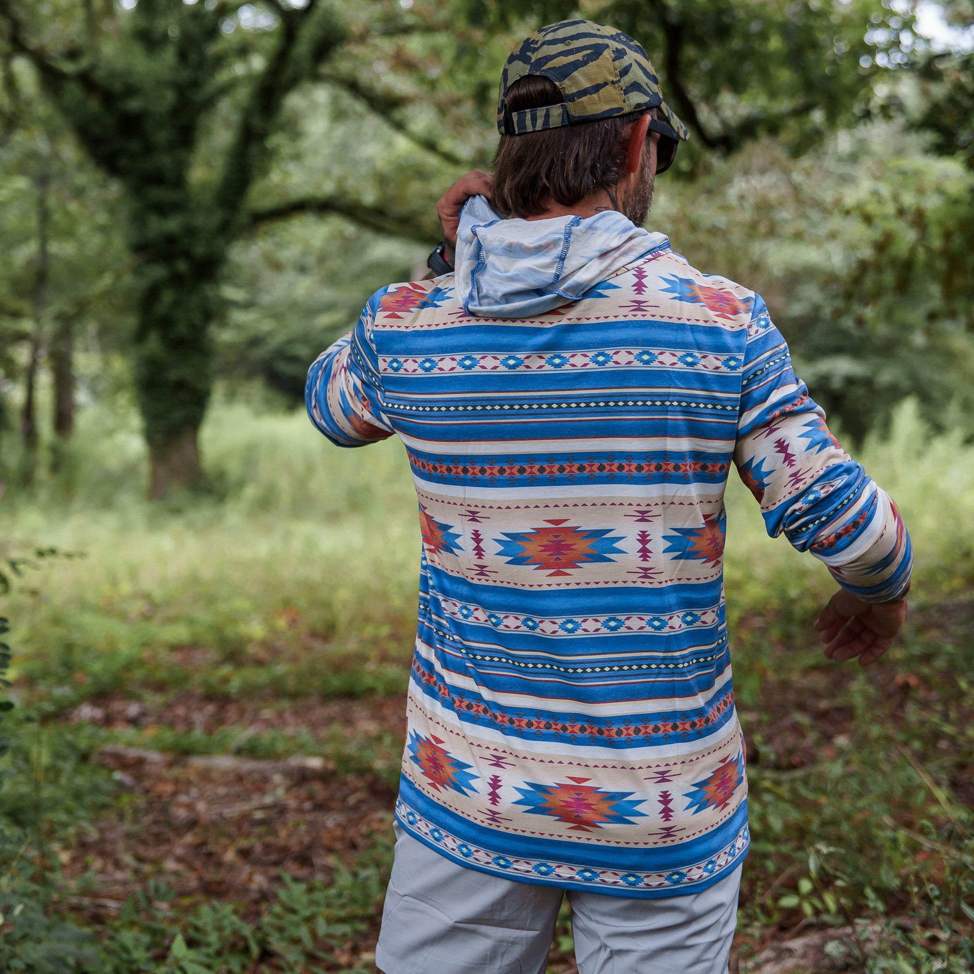 Men's Outdoors Long Sleeve Performance Hoodie by Combat Iron Apparel, worn by a man in an active outdoor style.
