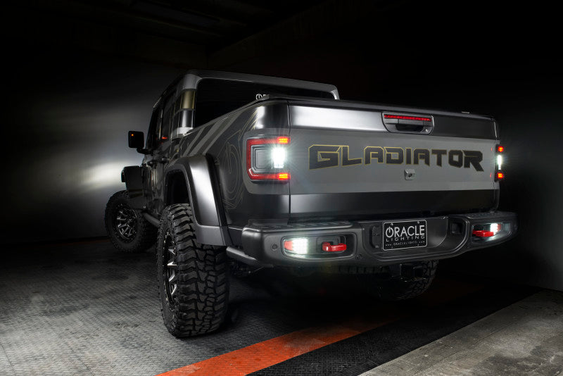 Jeep Gladiator JT with ORACLE Lighting Flush Mount LED Tail Lights in low light, capturing bright illumination feature.