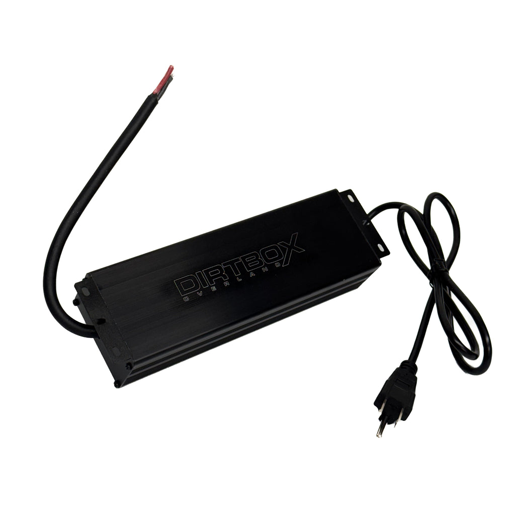 AC/DC Converter Kit by Dirtbox Overland, featuring a robust black casing, power input and output cables, perfect for outdoor adventures.