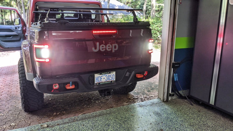 Stylish rear view of Jeep Gladiator JT showcasing ORACLE Lighting Flush Mount LED Tail Lights illuminated.