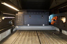 Load image into Gallery viewer, Interior view of Dirtbox Overland Front Storage Box in black, demonstrating its practical design and ample space for camping gear and tools.