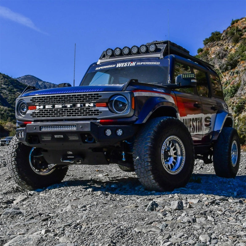 Dynamic shot of a Ford Bronco showcasing the Superwinch 21-24 Hidden Winch Mount, ideal for off-road adventures in challenging landscapes.