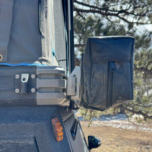 Load image into Gallery viewer, The Chunk Quick Release Bracket by Dirtbox Overland attached to an outdoor gear, demonstrating its versatility in accessory management.