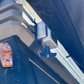Installation view of The Chunk Quick Release Bracket by Dirtbox Overland, highlighting its secure fit on an outdoor setup.