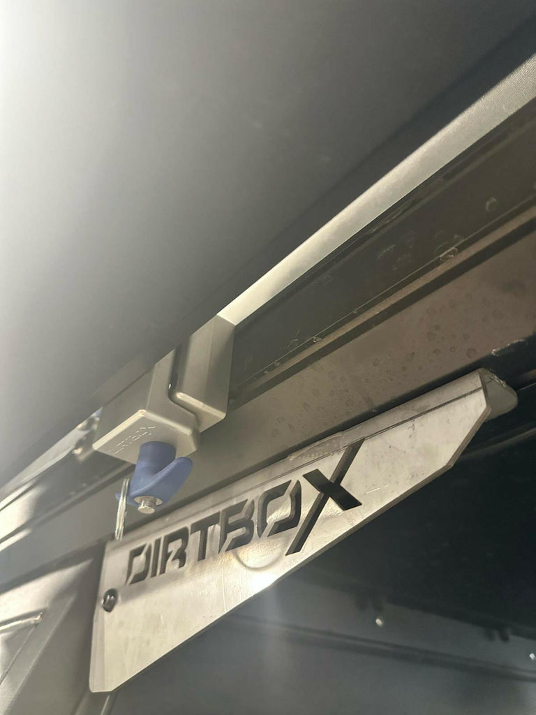 The Chunk Quick Release Bracket by Dirtbox Overland in a partially installed position, highlighting its user-friendly design.