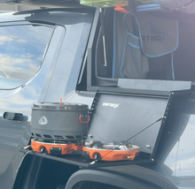 Load image into Gallery viewer, Close-up view of the Dirtbox Overland Hitch Hiker Folding Table featuring a Jetboil cooking unit, perfect for outdoor meals and adventures.