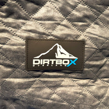 Load image into Gallery viewer, Dirtbox Overland logo on a soft quilted fabric, showcasing high-quality craftsmanship in the Canopy Camper Insulation Kit.