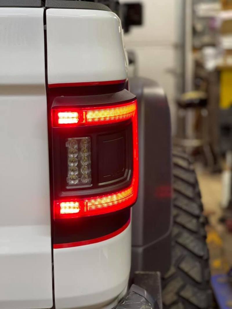 Close-up view of Jeep Gladiator JT featuring ORACLE Lighting Flush Mount LED Tail Lights illuminated.