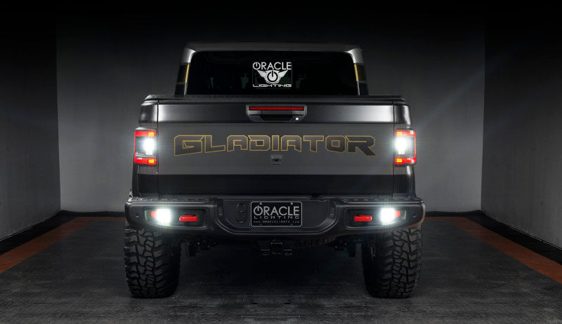 Jeep Gladiator JT from the rear, featuring ORACLE Lighting Flush Mount LED Tail Lights shining brightly.