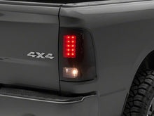 Load image into Gallery viewer, Raxiom 09-18 Dodge RAM 1500/2500/3500 Axial Series LED Tail Lights- BlkHousing- SmokedLens