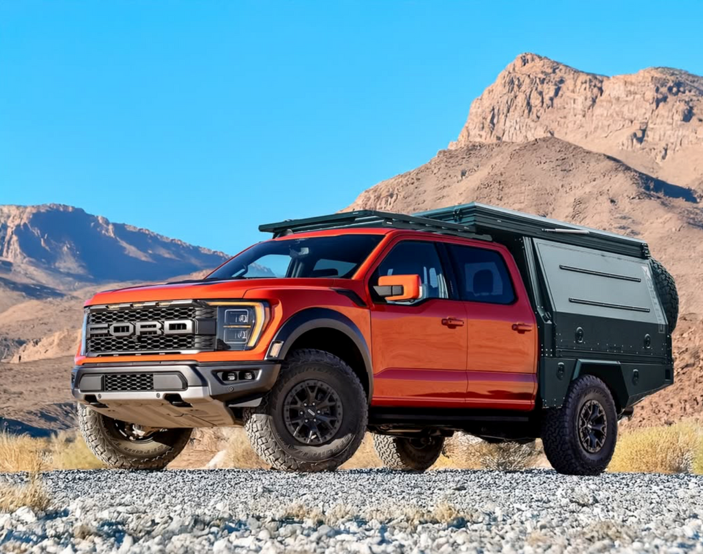 Vibrant orange truck featuring the Dirtbox Overland Flatbed System Full Box in a mountainous terrain, highlighting its customizable design for adventure seekers.