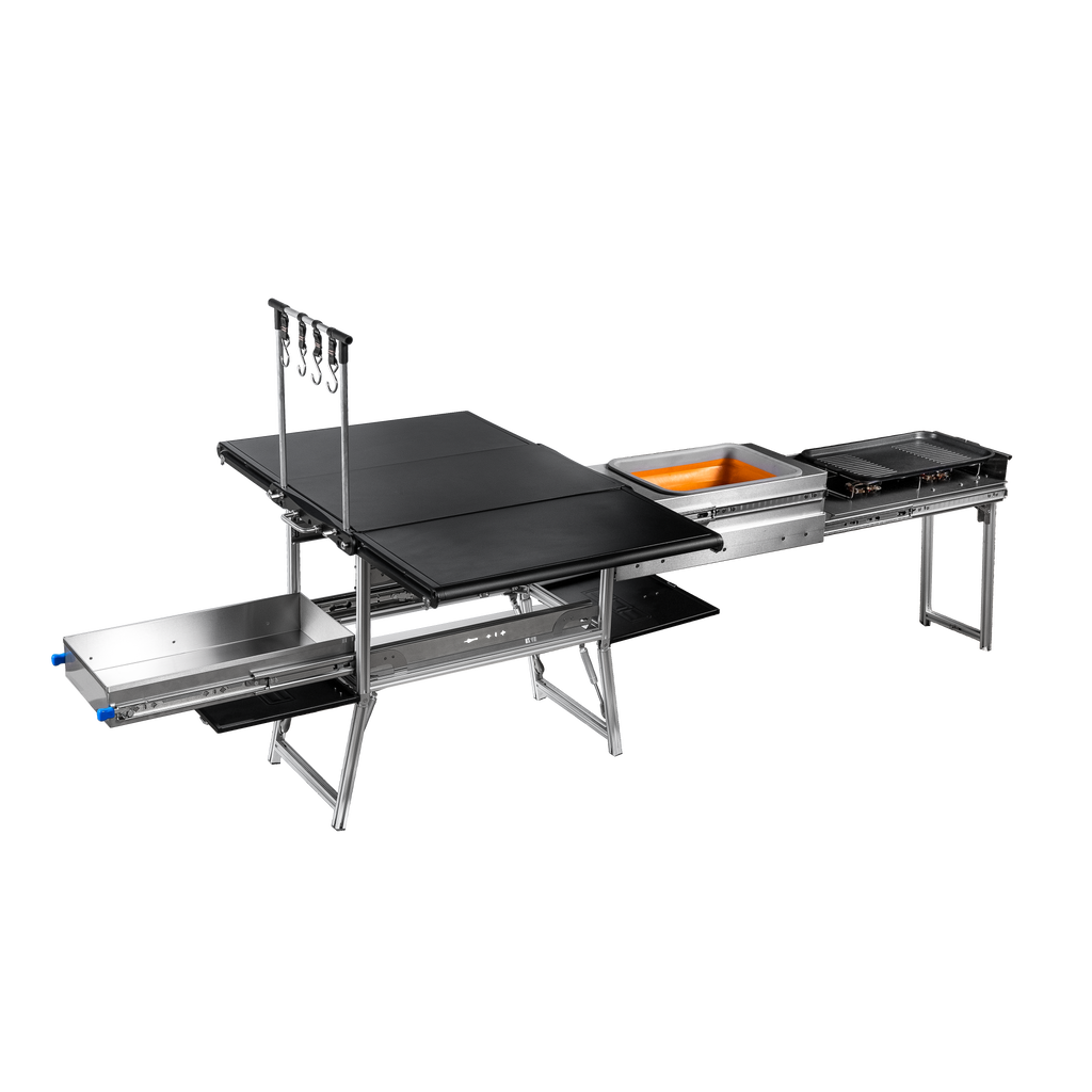 Quick Deploy Ground Kitchen Box by Dirtbox Overland featuring a compact, foldable design with integrated sink, two burners, a cutting board, and built-in table for outdoor cooking convenience.