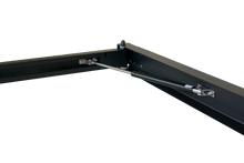 Load image into Gallery viewer, Close-up view of the 90 Degree Swing Out Bracket by Dirtbox Overland, showcasing its durable aluminum construction and gas strut mechanism for easy deployment.