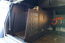 Load image into Gallery viewer, Interior view of a Dirtbox Overland Front Storage Box installed in a canopy camper, showcasing its sturdy design and space for outdoor gear.