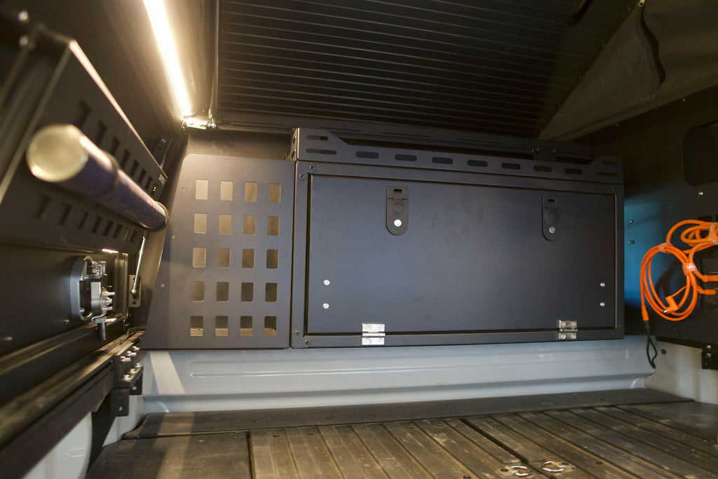 A functional Dirtbox Overland Front Storage Box fitted in a camper interior, demonstrating its versatility for efficient storage during outdoor trips.
