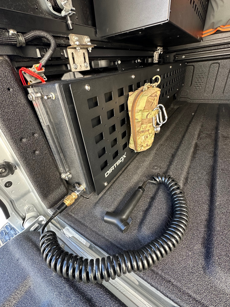 Dirtbox Overland In Bed 15 Gallon Water Tank installed in a truck bed, showcasing the rugged design and integrated pump for off-road enthusiasts.
