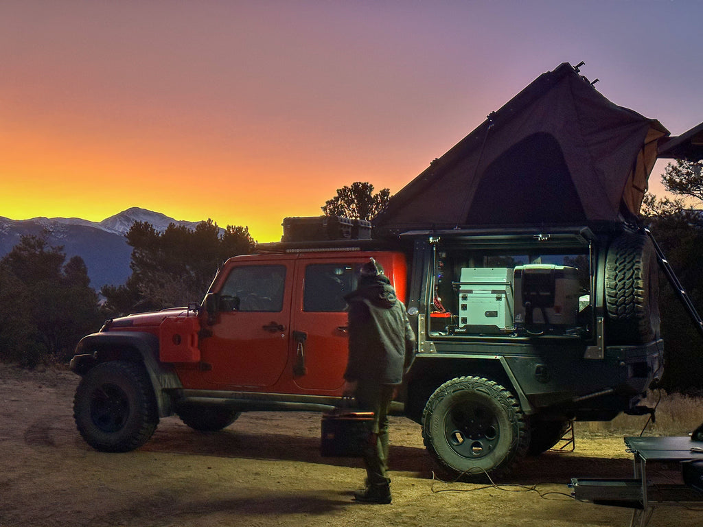 Dirtbox Overland Flatbed System Full Box setup at sunset, showcasing a rugged truck with a rooftop tent equipped for adventure.