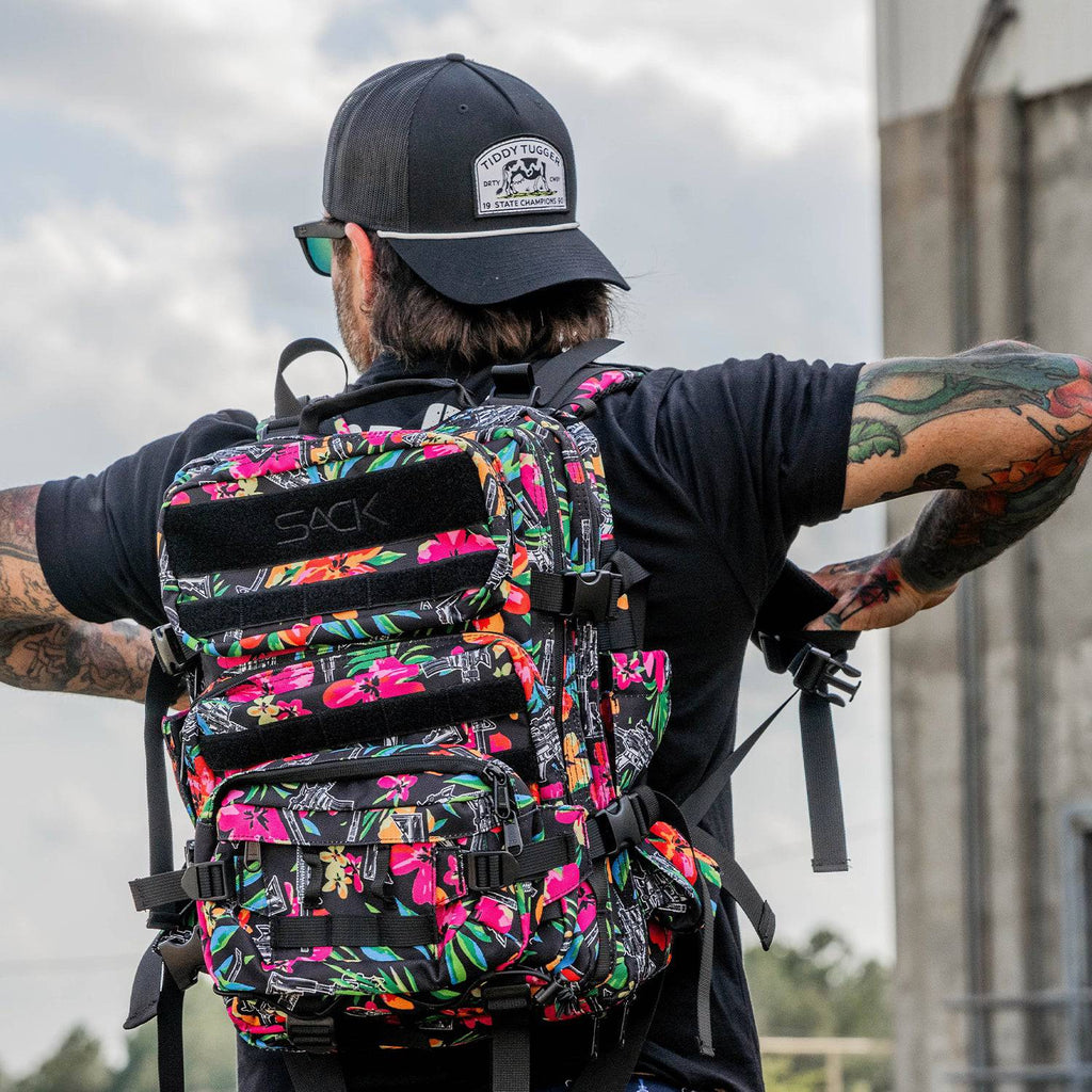 Combat Iron Apparel 25L Sack™ Original All-Day Molle Backpack with Pouch placed upright, highlighting its colorful design.