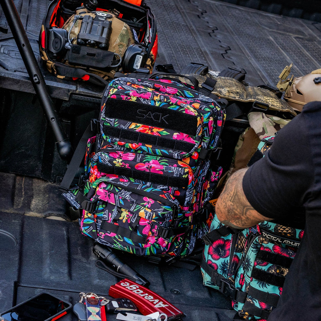 Combat Iron Apparel 25L Sack™ Original All-Day Molle Backpack with Pouch on display, showcasing its unique floral graphics.