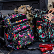 Load image into Gallery viewer, Combat Iron Apparel 25L Sack™ Original All-Day Molle Backpack with Pouch resting on a surface, displaying its vibrant floral aesthetic.