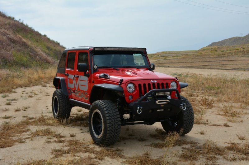 Metal Heat Dispersion Hood by DV8 Offroad on a red Jeep Wrangler with off-road accessories.