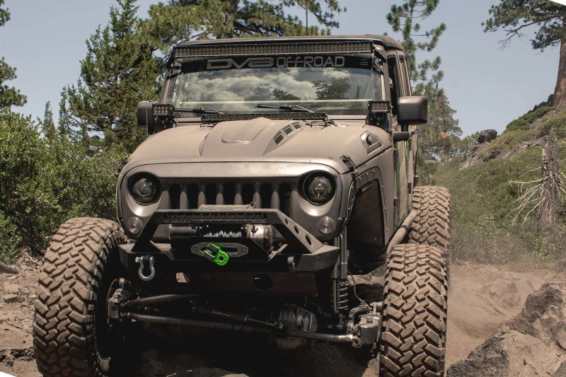 DV8 Offroad Jeep Wrangler JK with Metal Heat Dispersion Hood climbing rugged terrain.