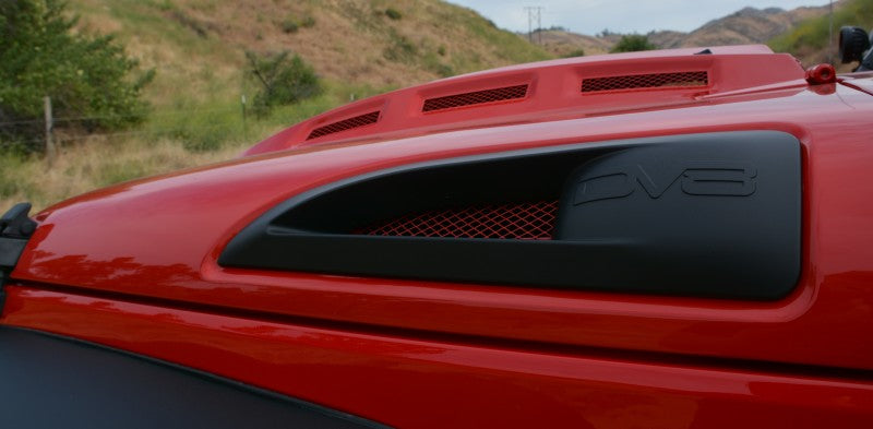 Side view of a red Jeep Wrangler JK with DV8 Offroad branding and Metal Heat Dispersion Hood.