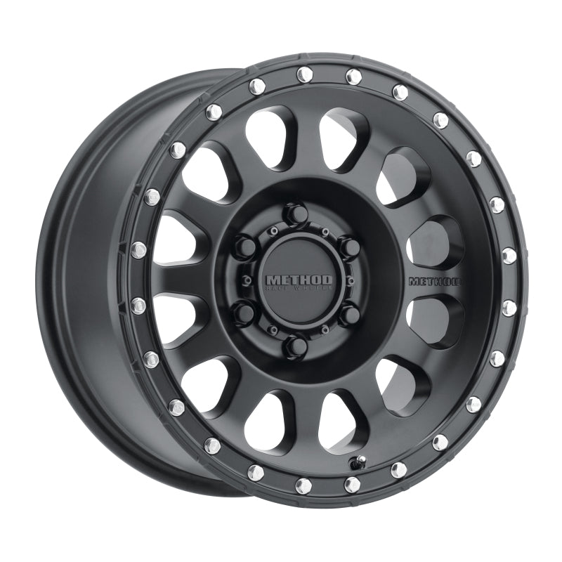 Method MR315 17x8.5 Matte Black Wheel featuring a rugged 12 spoke design with a debossed Method logo, showcasing weight-saving pockets and a beadlock style.