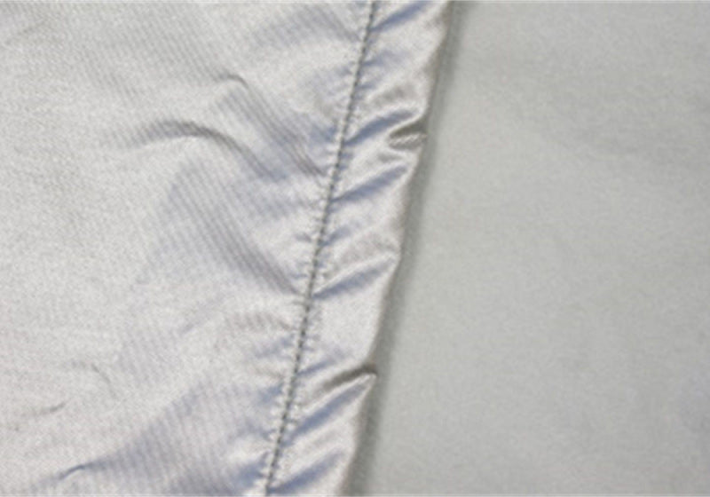 Close-up of the material of the Rampage 1999-2019 Universal Easyfit Truck Cover 4 Layer - Grey, highlighting its durable construction.