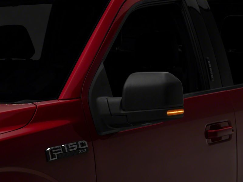 Raxiom Axial Series LED Mirror Mounted Turn Signals in action on a red Ford F-150, demonstrating bright LED lighting for enhanced visibility.