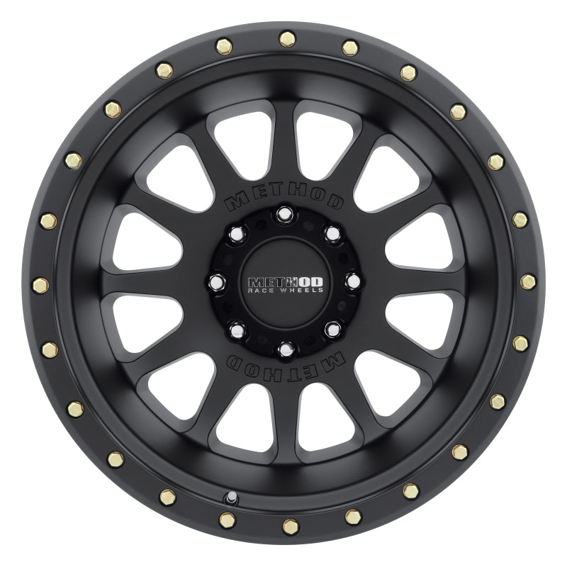 Top view of Method Wheels MR605 NV 20x9 wheel showcasing its matte black color and striking 12 window design with gold bolts.