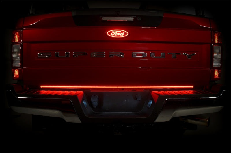 Putco 21-22 Ford F-150 60in Red Light Blade Direct Fit Kit Red/White visible on a red Ford Super Duty tailgate, showcasing a vibrant red tail light.