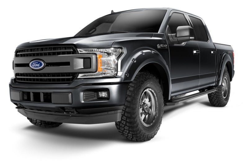 Bushwacker 18-19 Ford F-150 Pocket Style Flares in Shadow Black showcased on a rugged Ford F-150 pickup truck, enhancing its aggressive look and tire coverage.