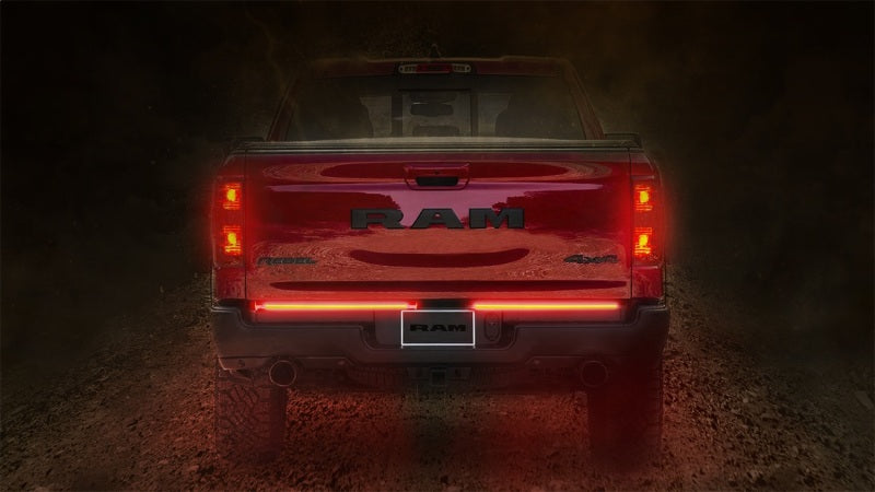 Putco 48-inch Light Blade Direct Fit Kit for Ford Ranger displayed on a RAM truck tailgate, illuminating in red for visibility.