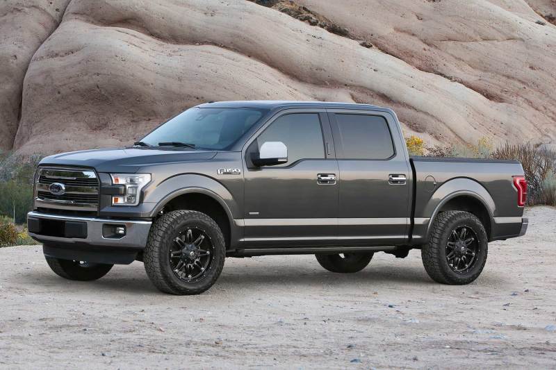 Fabtech 15-20 Ford F150 2WD 2in Uniball Upper Control Arm System showcasing a lifted gray Ford F-150 with black rims, perfect for off-road adventures.
