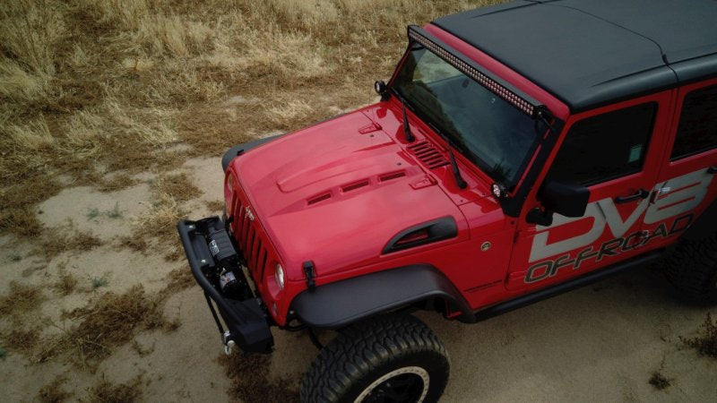 Close-up of the DV8 Offroad Jeep hood showing the brand logo and aggressive design.