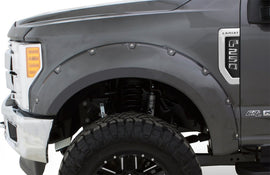 Close-up of a Ford F-250 Lariat truck showcasing Bushwacker 18-19 Ford F-150 Pocket Style Flares in Shadow Black.