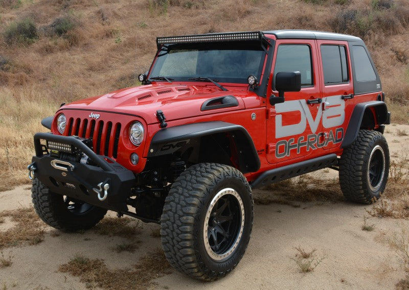 Black Jeep Wrangler JK by DV8 Offroad navigating rocky terrain, showcasing the Metal Heat Dispersion Hood.