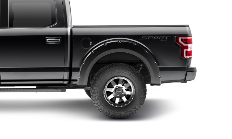 Side view of a black Ford F-150 featuring Bushwacker 18-20 Pocket Style Fender Flares, adding rugged aesthetics and tire coverage.