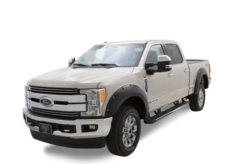 A side view of a Ford Super Duty truck featuring Bushwacker 18-19 Ford F-150 Pocket Style Flares in Shadow Black.