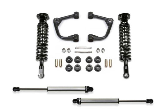 Fabtech 15-20 Ford F150 4WD 2in Uniball UCA System parts including upper control arms, coilover shocks, and hardware, designed for off-road performance.