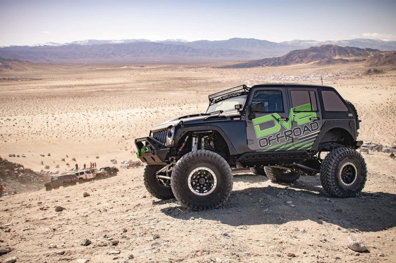 Detailed view of the DV8 Offroad Metal Heat Dispersion Hood on a red Jeep Wrangler JK.
