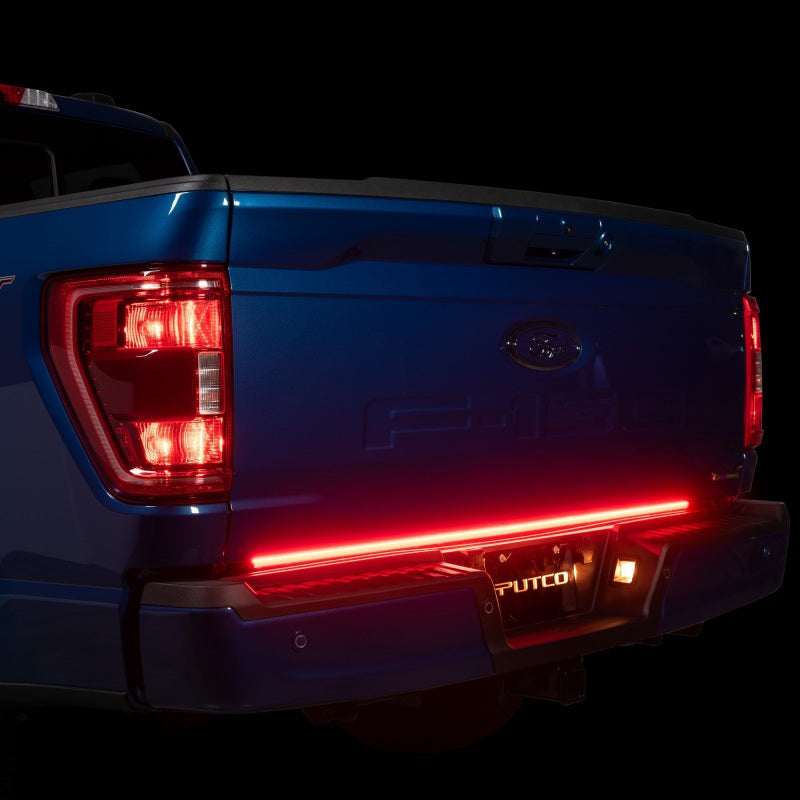 Putco 60in Red Light Blade Direct Fit Kit installed on a 2021-2024 Ford F-150, featuring red LED lights shining brightly from the tailgate.