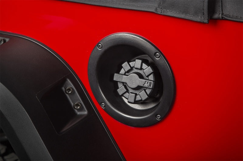 Rugged Ridge 01-19 Jeep Wrangler Black Elite Aluminum Fuel Cap on a red Jeep, showcasing compatibility.